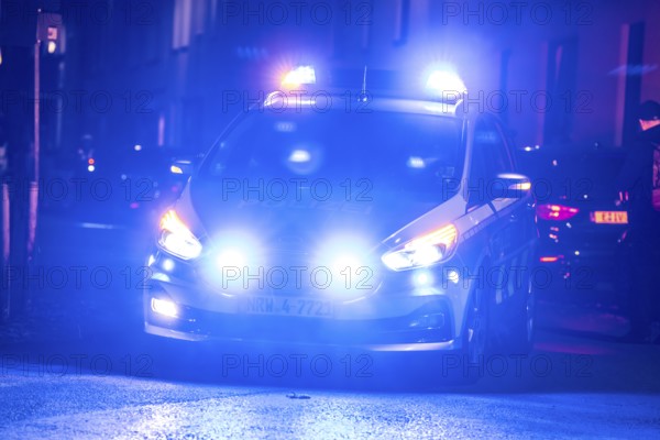 Police patrol car deployed with flashing lights, Essen, North Rhine-Westphalia, Germany