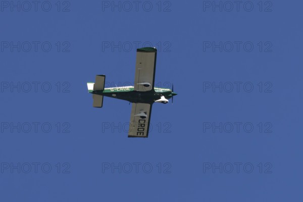Robin HR200-120B light aircraft flying in a blue sky, England, United Kingdom