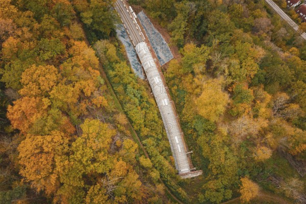 Aerial view of a railway construction site surrounded by autumn trees, along the tracks, Hermann-Hesse-Bahn construction site, Calw, Germany