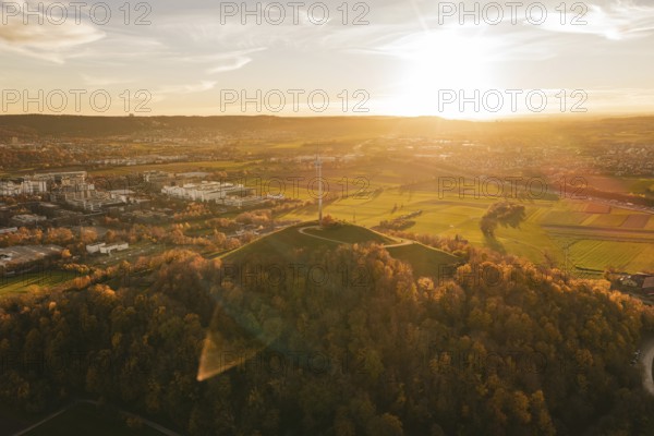 A wide landscape with fields, wind turbine and forest at sunset, Grüner Heiner, Korntal, Germany