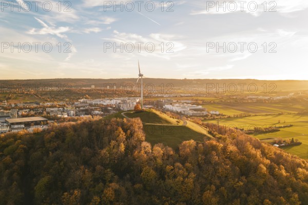 A panoramic view of an urban landscape with wind turbine on a hill, Grüner Heiner, Korntal, Germany