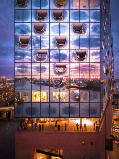 Aerial view of the Elbe Philharmonic Hall with reflections on the façade in the evening light above the harbor, Hamburg, Germany