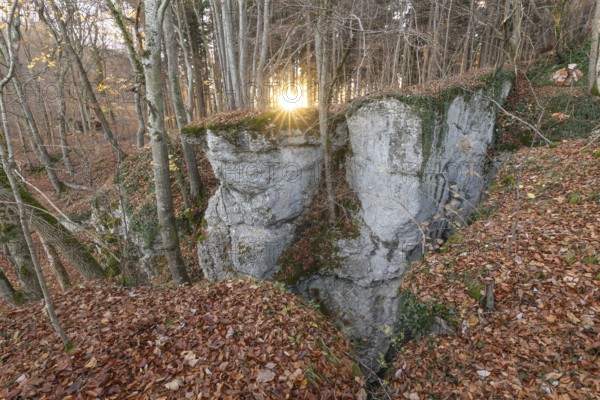 Low sun illuminates the rocks and caves of hell holes in the autumnal landscape of Dettingen an der Erms Baden-Württemberg Germany