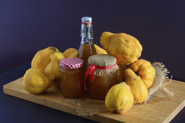 Still life with quinces, homemade quince jelly and quince liqueur, autumn, Germany