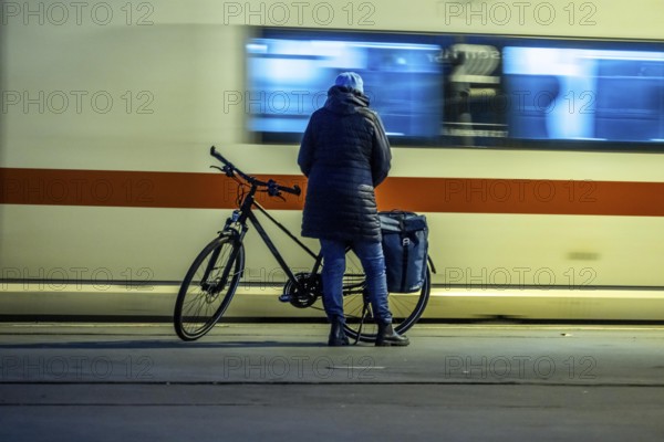 Cyclists waiting for the train, in Essen main station, on the platform, North Rhine-Westphalia, Germany