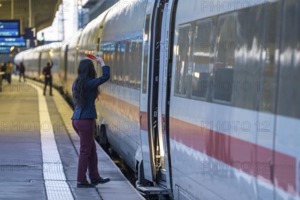 ICE train ready for departure, train staff waiting for the signal to continue, at Essen main station, on the platform, North Rhine-Westphalia, Germany