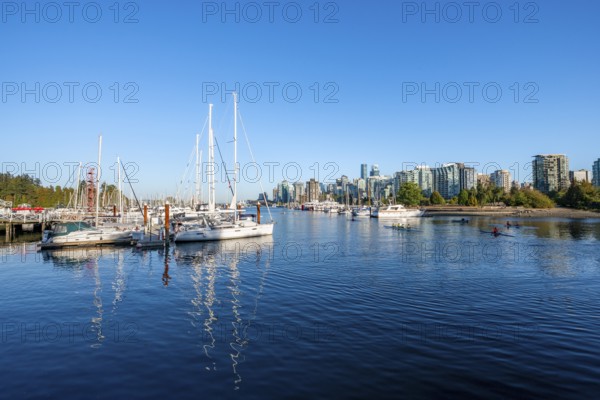 Skyscrapers and sailboats in the marina, Vancouver skyline reflected in the ocean, Coal Harbour, Downton Vancouver, British Columbia, Canada