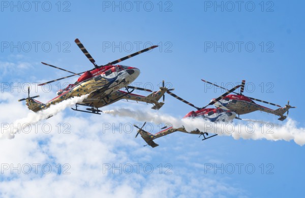 Indian Air Force (IAF) ALH Mk1 Sarang helicopters soar through the sky during an air show as part of the 93rd Air Force Day celebrations on November 8, 2025 in Guwahati, India