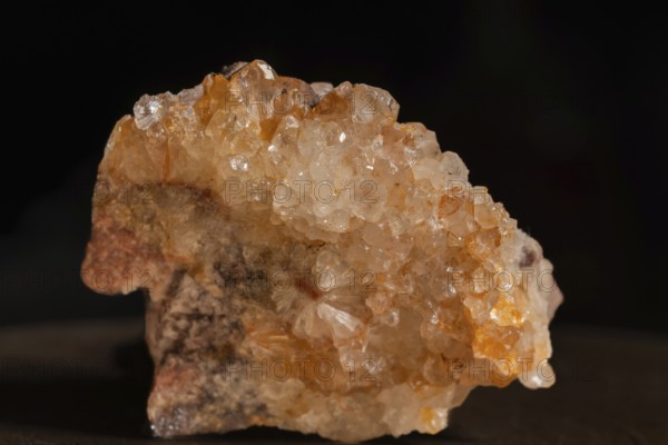 Quartz soil with sparkling crystals that are exposed on a grey surface. The lighting highlights the facets and reflections of the stones. Bas Rhin, Alsace, France