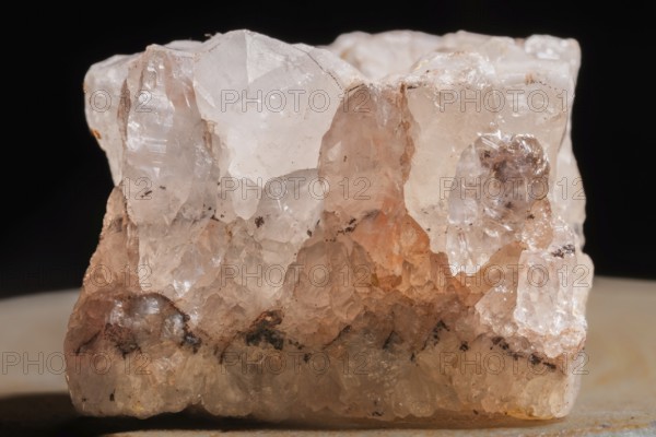 This clear quartz crystal is highlighted by its fascinating structure. Details of its surface shimmer in the light and contrast with the dark background. Bas Rhin, Alsace, France