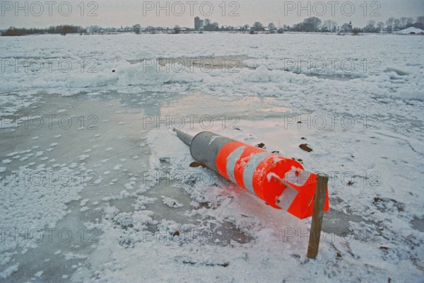 Buoy lying on ice rink, frozen Elbe, Bleckede, Lower Saxony, Germany, January 03, 1997, vintage, retro, old, historic