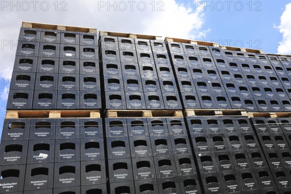 Stacked black beer crates from the Kulmbacher Group, a beverage manufacturer that includes Kulmbacher Brauerei AG and other breweries such as Sternquell, Braustolz and Würzburger Hofbräu, editorial