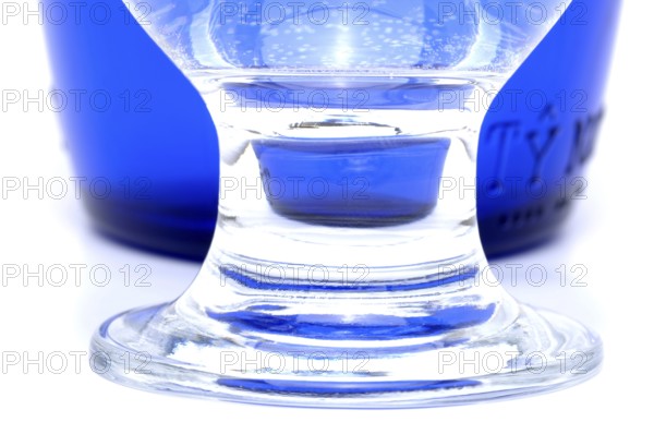 Glass with mineral water, small carbonated pearls on the edge of the glass, drinking water