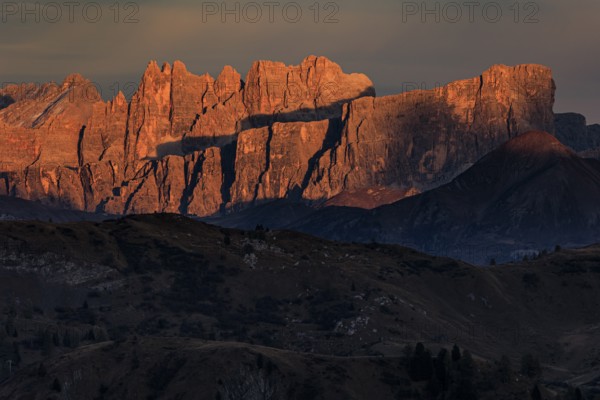 Steep mountains, mountain range, sunset, cloudy, autumn, Pordoi Pass, view of Croda da Lago, Dolomites, Italy