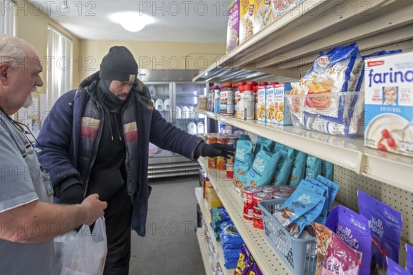 Detroit, Michigan USA - 4 November 2025 - People pick up groceries at the nonprofit Deo Gratias Food Pantry, operated by theFelician Sisters. Demand for emergency food at food pantries and soup kitchens has risen dramatically since the federal government shutdown cut SNAP benefits