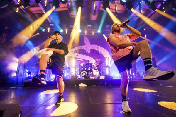 Carlito (Carlos Charlemoine) and Mal Élevé (Pablo Charlemoine), singers from Irie Révoltés live on Irieunion - Le Re-Tour pour une année! Tour in Berlin's Columbiahalle on 31.10.2025