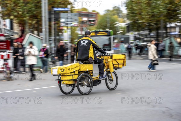 Delivery agent, Deutsche Post mailman on e-bike, Bochum, North Rhine-Westphalia, Germany