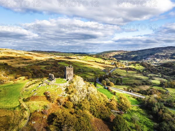 Autumn colours over Castell Dolwyddelan and Eryri Mountains from a drone, Snowdonia, Conwy County Borough, Wales, England, United Kingdom