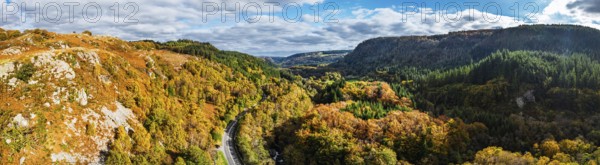 Autumn colours over Gwydir Forest Park from a drone, Afon Lledr, Road A470, Snowdonia, Eryri, Wales, England, United Kingdom