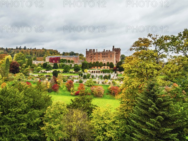 Autumn colours over Powis Castle and Garden from drone, Welshpool, Powys, Wales, England, United Kingdom