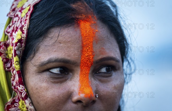 A Hindu devotee offer prayers to the Sun God on the bank of Brahmaputra river on the occasion of Chhath Puja, in Guwahati, India on 27 October 2025