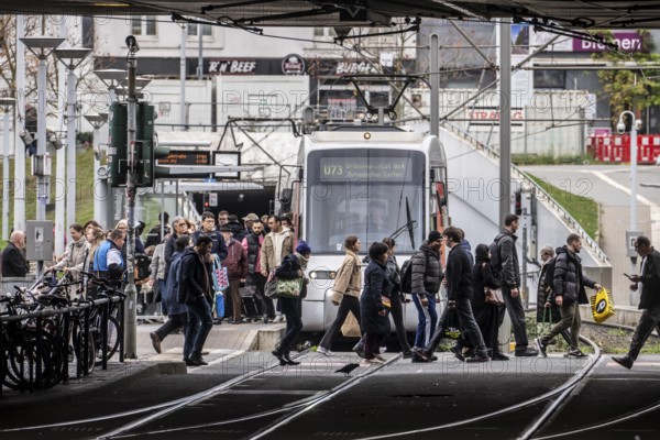 Pedestrians cross the tram tracks, at Düsseldorf-Bilk station, junction of S-Bahn, subway, tram, local bus transport, North Rhine-Westphalia