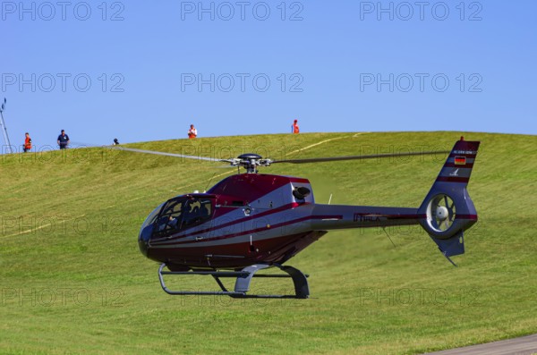 A Eurocopter EC 120B Colibri helicopter, D-HALX registration, during a flight demonstration as part of an air show on Rossfeld in Metzingen-Glems, Baden-Württemberg, Germany, for editorial use only