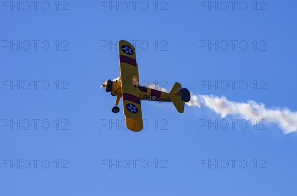 A Boeing PT-17 Stearman biplane, also Boeing Stearman Model 75, with the inscription 399 USNAVY N67193 during a flight demonstration as part of an air show on Rossfeld in Metzingen-Glems, Baden-Württemberg, Germany, for editorial use only