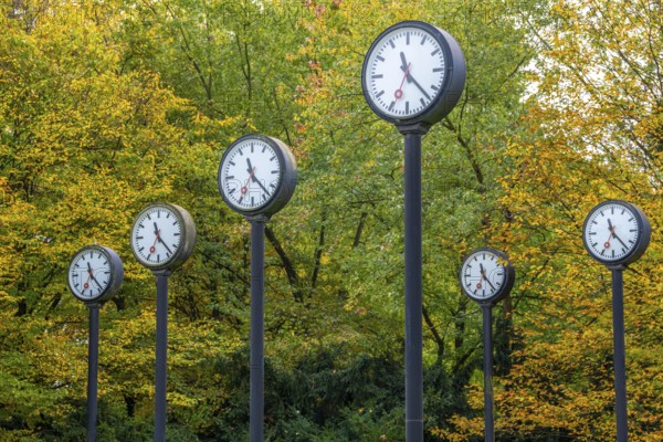 The art installation Zeitfeld in Volksgarten Park in Düsseldorf-Oberbilk, a total of 24 station clocks, on 6 meter high steel columns, have been running synchronously since 1987, artwork by Düsseldorf artist Klaus Rinke, symbol of time, time change, North Rhine-Westphalia, Germany