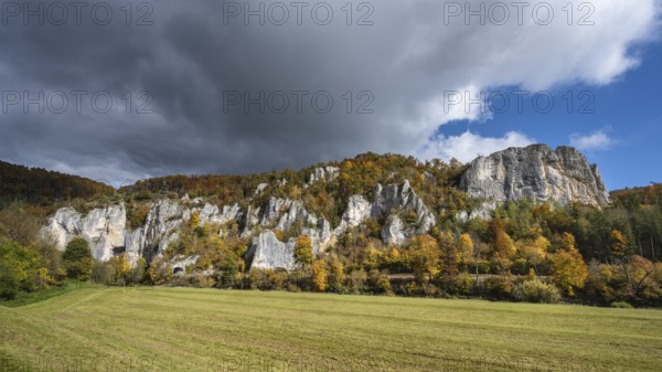 Distinctive Jurassic limestone cliffs in the upper Danube Valley, surrounded by autumn vegetation, on the right the raven rocks, Sigmaringen district, Baden-Württemberg, Germany