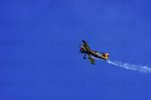 A Votec 351 sport aircraft from the Swiss MSW Aviation AG with registration HB-YMV during a flight demonstration as part of an air show on Rossfeld in Metzingen-Glems, Baden-Württemberg, Germany, for editorial use only