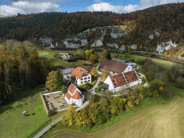 Aerial view of Käppeler Manor with St. George's Basilica near Thiergarten in the Upper Danube Valley, surrounded by autumn vegetation, Sigmaringen district, Baden-Württemberg, Germany