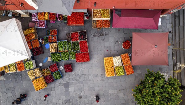 Traditional Mexican plaza with crates of peppers, onions, and tomatoes, economic prosperity in local trade, travel destination in America, AI generated