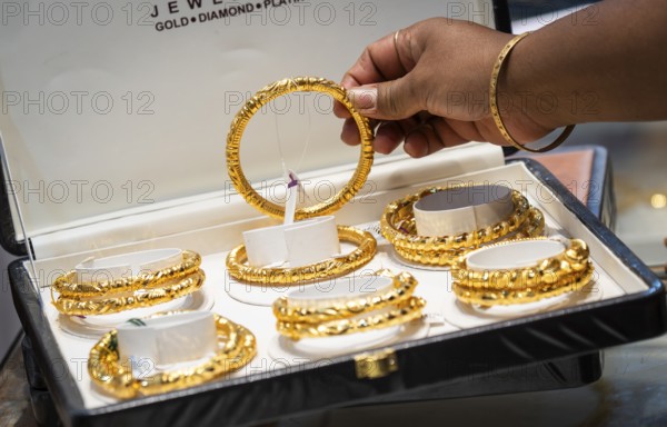 Customers purchase Gold jewelry at a store on the occasion of the festival of Dhanteras, in Guwahati, Assam, India on 18 October 2025. People rushing to buy gold even after its nearly 60% surge to record highs this year