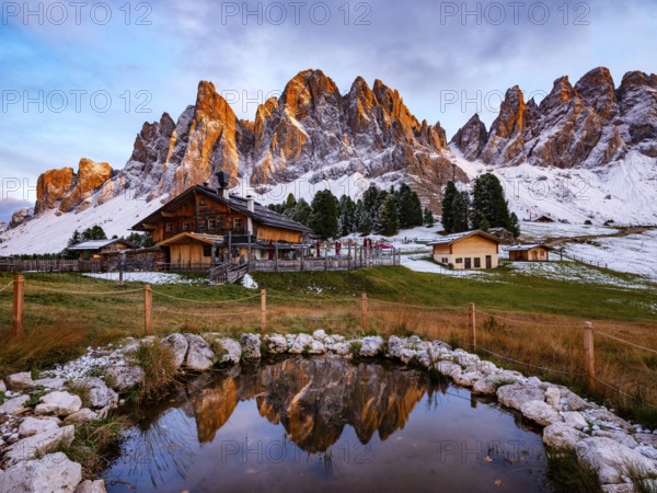 Geisleralm with Geisler Group in Alpenglühen, reflection, Dolomites, Santa Magdalena, Trentino, South Tyrol, Italy