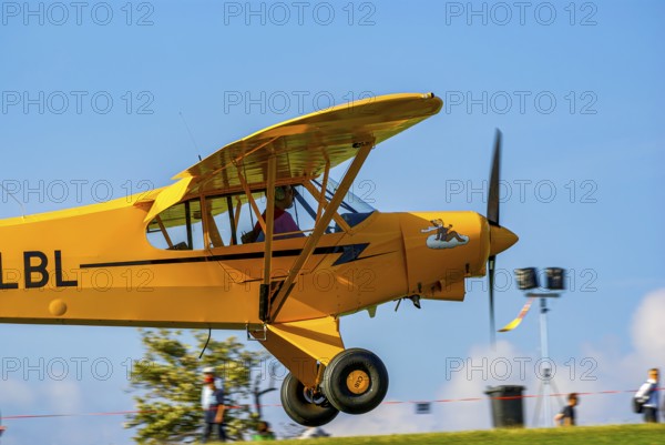 A Piper PA-18 Super Cub of the Bravo Lima Formation during a flight demonstration as part of an air show at the Rossfeld in Metzingen-Glems, Baden-Württemberg, Germany, for editorial use only