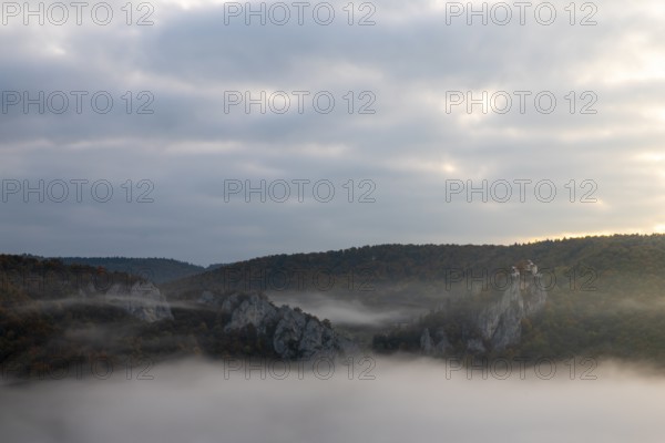 View from the Knopfmacherfelsen to Bronnen Castle, limestone rock, rock face, mixed forest, autumn colours, fog, autumn, Fridingen, Danube Valley, Upper Danube nature park Park, Baden-Württemberg, Germany