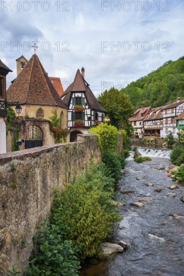 Picturesque Kaysersberg with half-timbered houses on the Weiss river in the old town centre