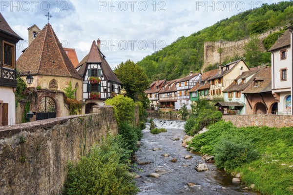 Picturesque Kaysersberg with half-timbered houses on the Weiss river in the old town centre