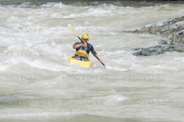 Young man kayaking in river, Costa Rica, Central America