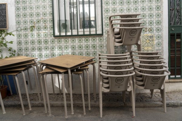 Restaurant furniture, for outdoor catering, tables, chairs, stacked, day off, catering closed, old town of Tavira, Algarve, Portugal