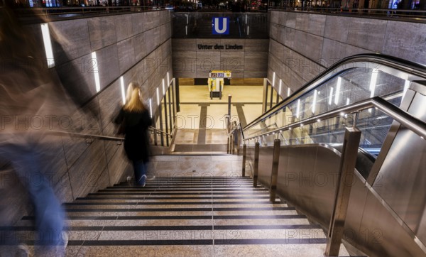 Night photo, long exposure with motion blur, modern underground entrance at Unter den Linden station, contemporary design with stairs and escalator, Berlin, Germany