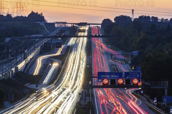 Motorway near Stuttgart with several lanes in the evening with sunset. Heavy traffic with light lanes. BAB 8 motorway near Wendlingen, Baden-Württemberg, Germany