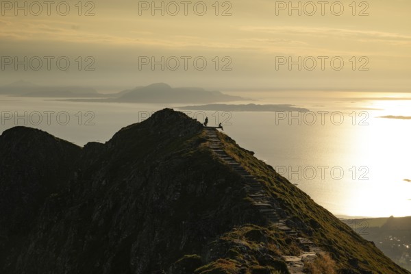 Hikers on the Rørsethornet stone staircase, with 3292 steps one of the longest continuous stone staircases in the world, Sherpatreppe or Midsundtreppe or Midsundtrappene, Rørsethornet hike, evening mood, Otroya or Otrøya island, Møre og Romsdal, Norway