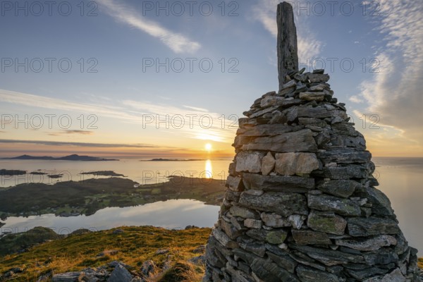 View of the Norwegian coast from the Rørsethornet stone steps, with 3292 steps one of the longest continuous stone steps in the world, Sherpat stairs or Midsund stairs or Midsundtrappene, Rørsethornet hike, cairns, sunset, Otroya or Otrøya island, Møre og Romsdal, Norway