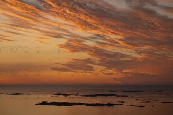 Offshore islands and skerries, sea, dramatically illuminated clouds, sunset, Otroya or Otrøya island, Møre og Romsdal, Norway