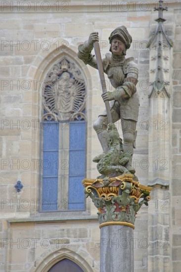 Sculpture of St George with stabbing weapon fighting dragons at St George's Fountain, detail, Holzmarkt, Tübingen, Neckar Valley, Baden-Württemberg, Germany