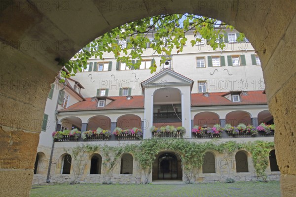 Protestant monastery built in 1534, inner courtyard with arcade and floral decoration, archway, former Augustinian monastery, Tübingen, Neckar Valley, Baden-Württemberg, Germany