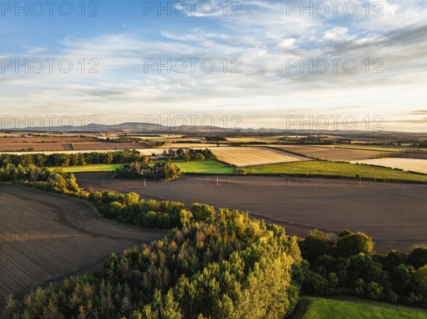 Sunset of Farms and Fields over Norham Castle from a drone, Norham, River Tweed, Northumberland, England, United Kingdom