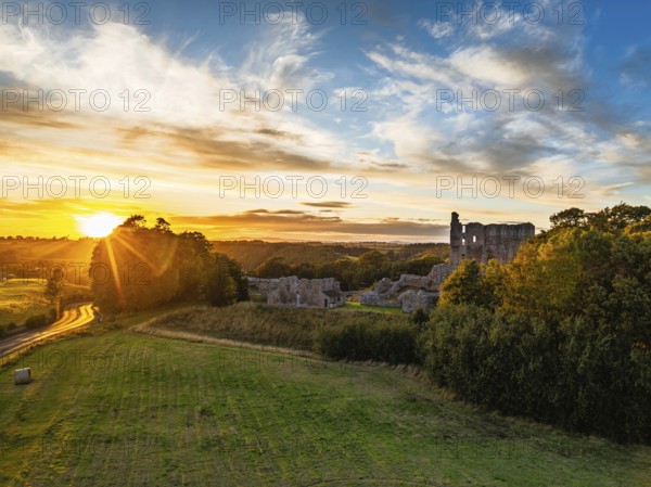 Sunset over Norham Castle and River Tweed from a drone, Norham, Northumberland, England, United Kingdom